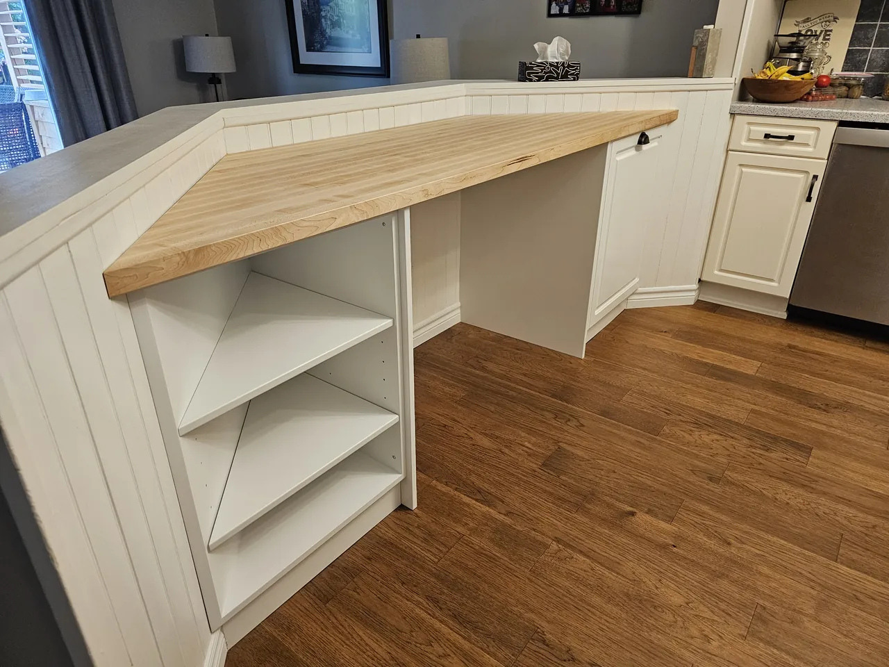 Corner desk with open shelving and a maple top