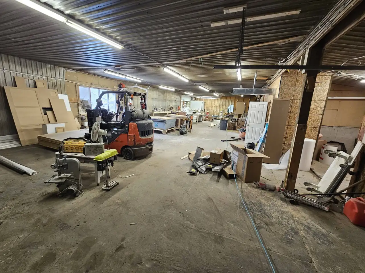 The Hailey Inc shop floor with cabinet boxes, a forklift and panel stock