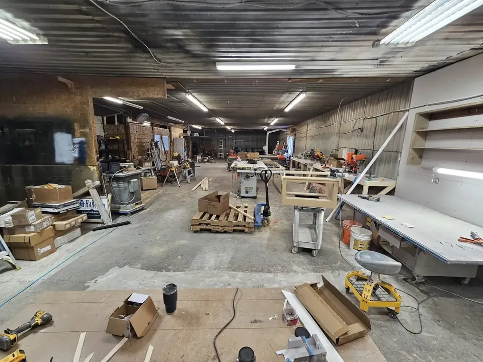 Work tables and cabinet parts in the Hailey Inc shop